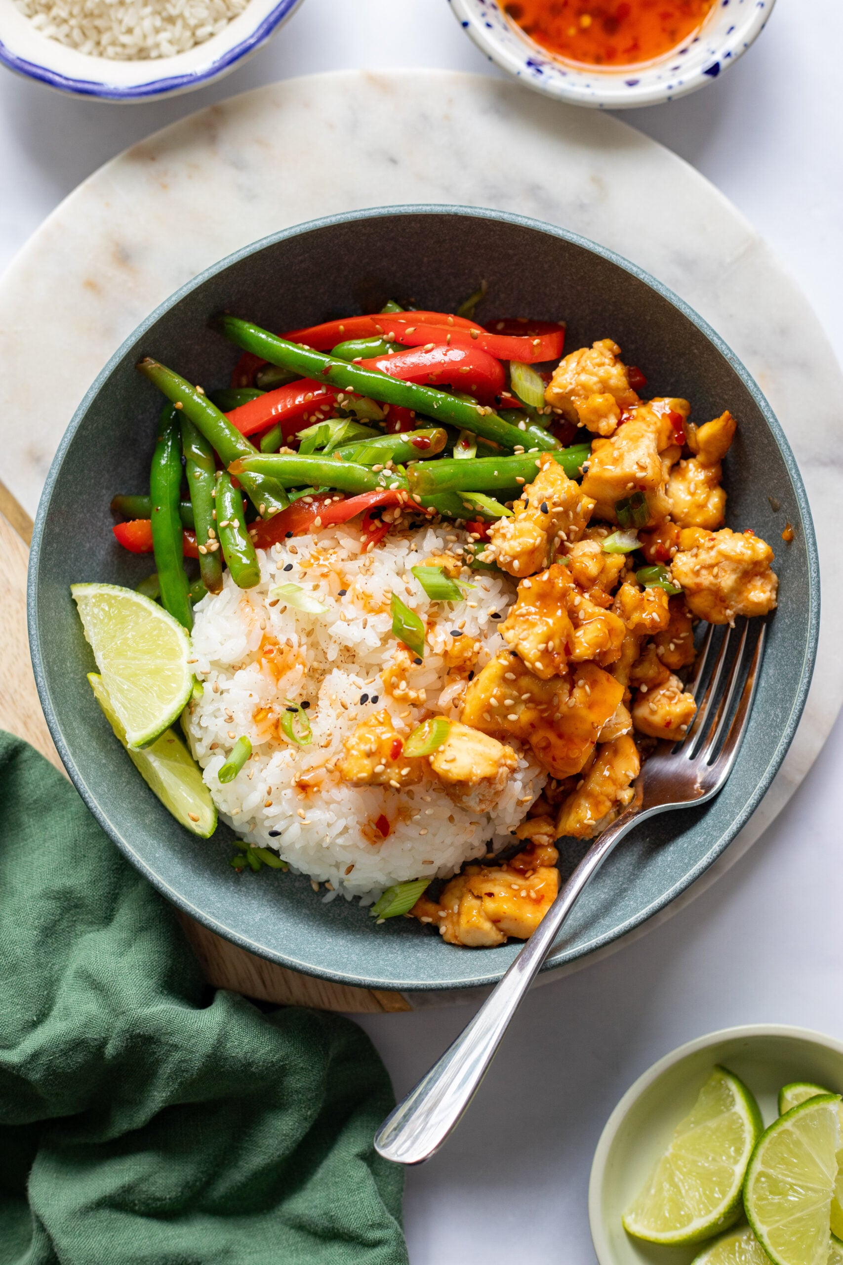 sticky tofu in a bowl with rice and stir fried vegetables. 