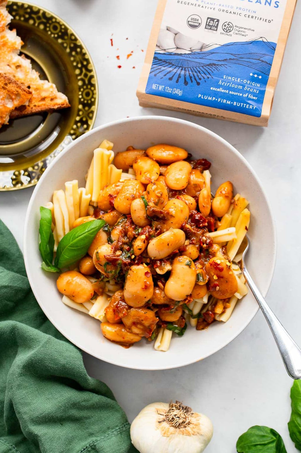 marry me beans over pasta in a bowl
