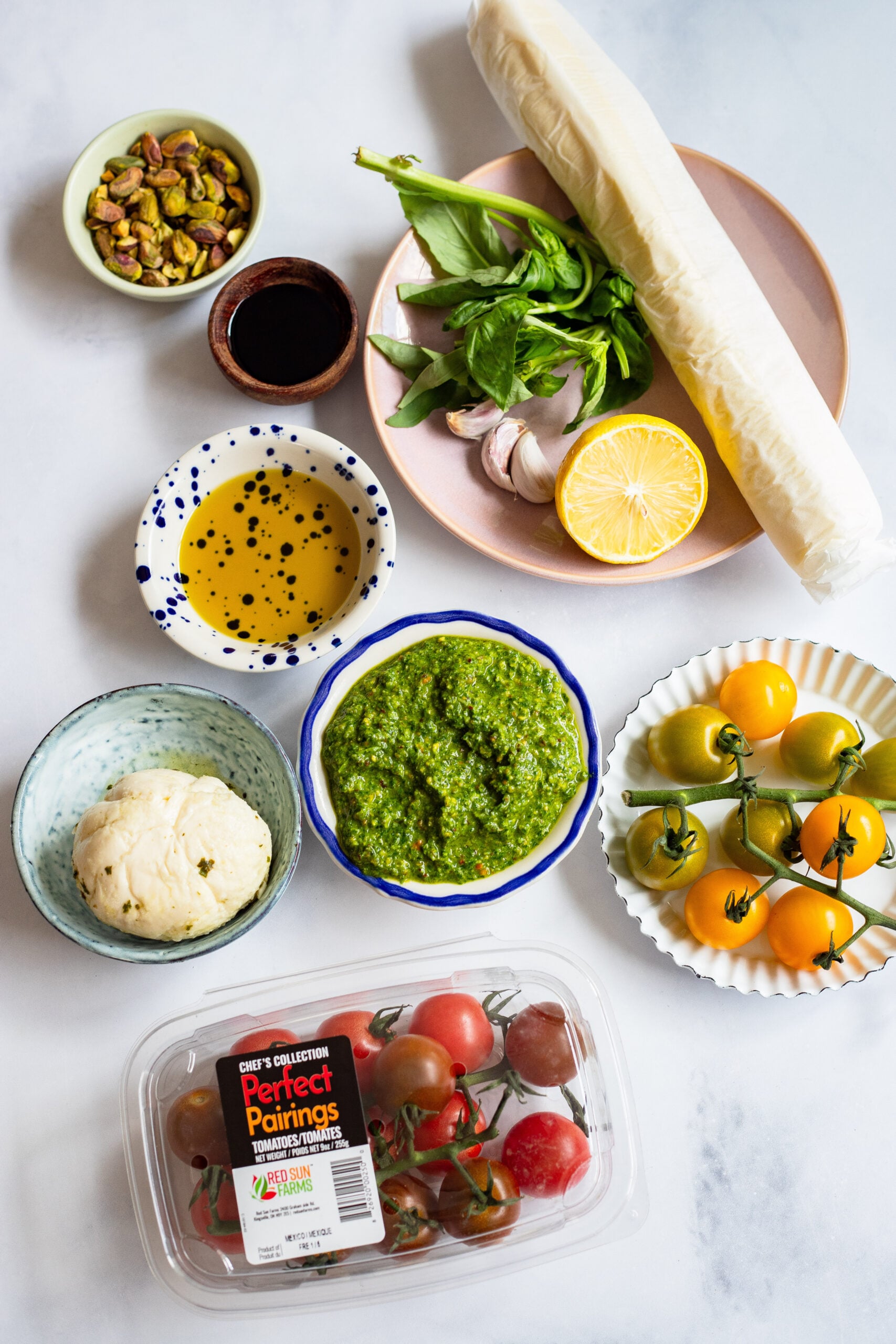 tomato basil tart ingredients arranged on a white background