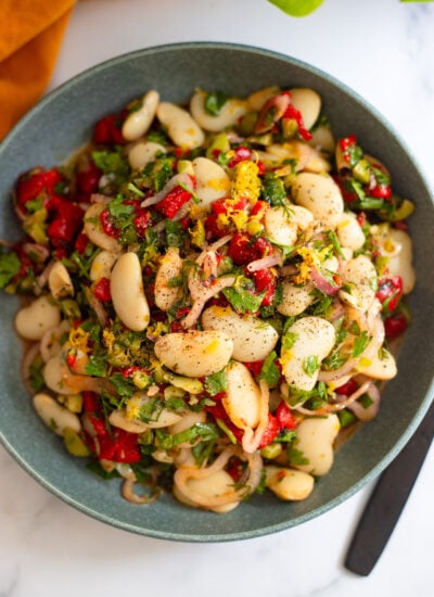 marinated butter beans in a blue serving bowl
